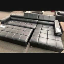 New Modern Sectional W Large Ottoman .  Black Leather.  117” X 69”.  Free Delivery !