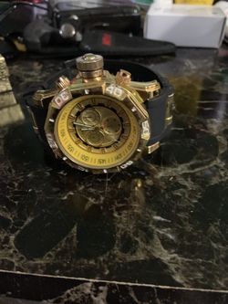 Gold plated and black watch