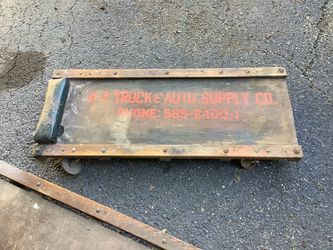 Vintage auto mechanics creepers made of hardwood deck with metal reinforced rails. Both fully functional but one does have a few issues with wood
