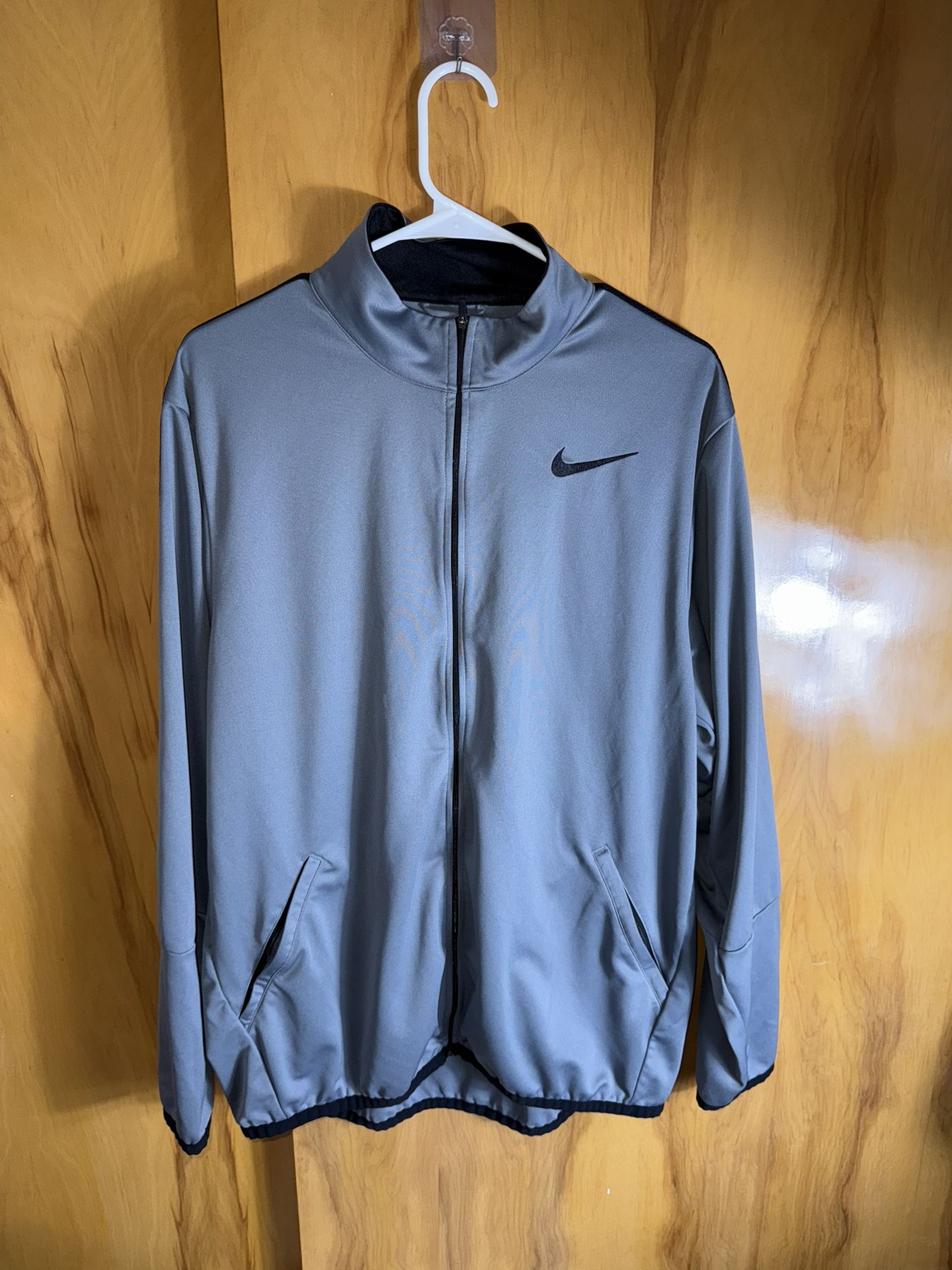 This is a Nike Dri-FIT Epic Knit Training Jacket in grey and black.