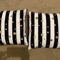 Two Black and White Striped Throw Pillows with Gold Polka Dots