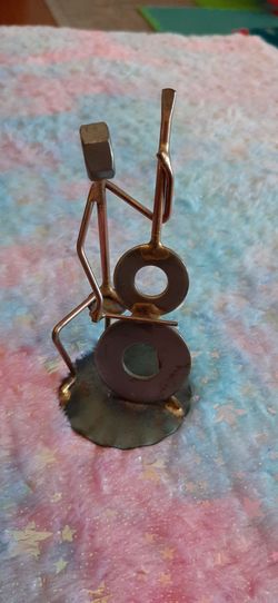 Metal scrap art figurine of a cellist