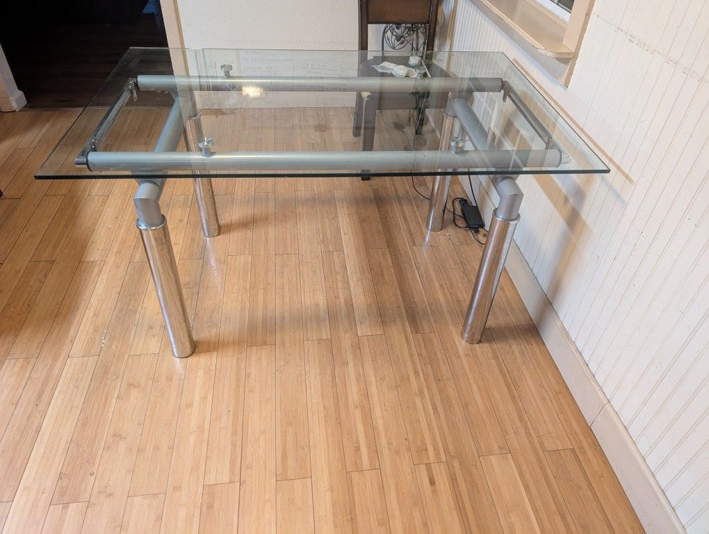 Glass Dinning Table With Chromed Metal Base (55x35.5 Inch / Tall 30 Inch)