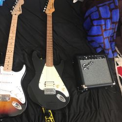 Two Electric Guitars With An Amp