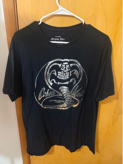 This is a black Fifth Sun brand graphic t-shirt featuring the Cobra Kai snake logo in a metallic silver design XL on tag  Very good condition  Smoke f
