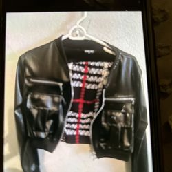 Woman’s Faux, leather jacket, crop top style with mini skirt with a small slit going up the side