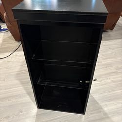 Black showcase with glass shelves