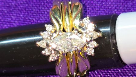 14K Yellow Gold  Diamond Ring  with 3/4 carat marquis cut center stone surrounded with smaller diamonds  size 7 weighs 8 grams