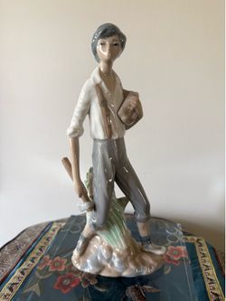 Vintage Casades Spain porcelain figurine titled "Boy with Axe and Logs"