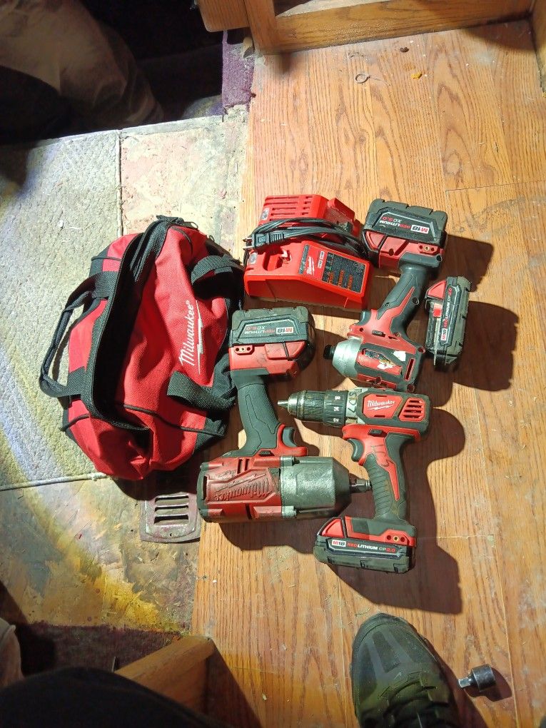 Milwaukee Drill And 1/4 Inch Impact Combo Plus 1/2 Inch Impact Wrench 4 Batteries Charger And Milwaukee Tool Bag