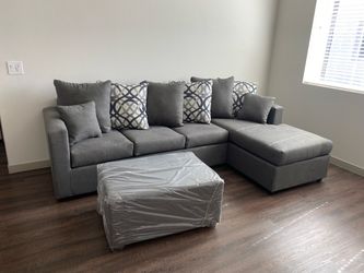 Brand new grey sectionals with free ottoman