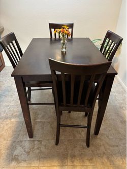 Dark solid wood table and chairs
