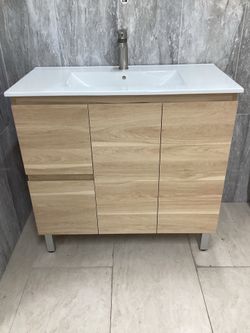 36” vanity, pvc, oak, ceramic top, available for pick up