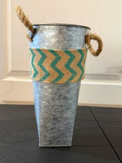 Metal vase with teal ribbon About 11 inches tall and about 6 1/4 inches wide at the top