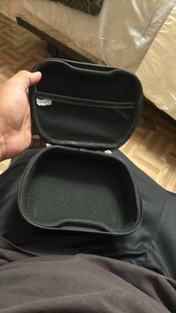 Selling a black, hard-shell travel carrying case for gaming controllers. Great condition, zipper works perfectly, and has an inner mesh pocket for cha