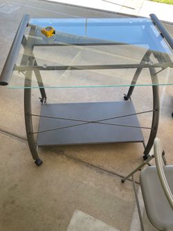Glass top desk with bottom shelf