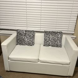 REDUCE PRICE  $75 Compact White Leather Loveseat with Zebra Accent Pillows