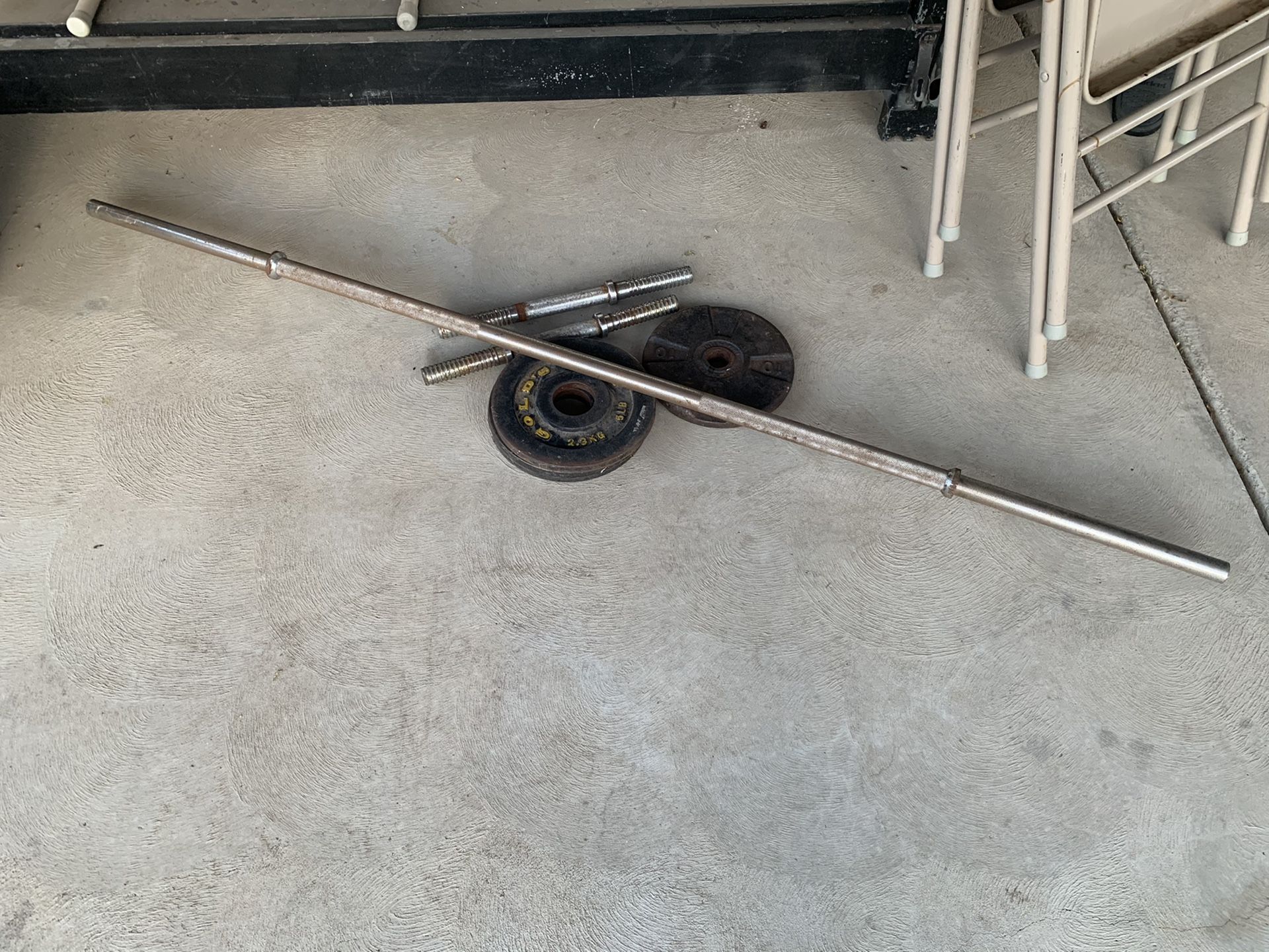 Assorted gym weights and bars