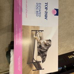 a Top Paw Elevated Dog Bed with a metal base and orthopedic foam. This specific model is designed for indoor use and features supportive bolsters.