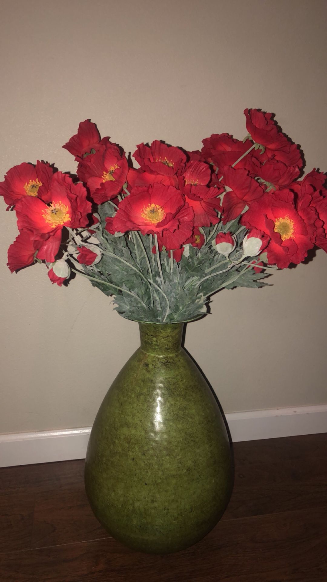 Large green vase with flowers