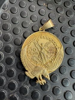 Mexican Centenario "50 Pesosp" coin pendant, frequently featured in gold-plated versions.