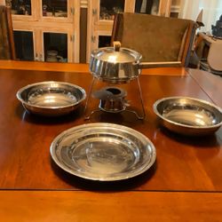 A Stainless Steel Fondue And 3 Platters