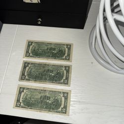 three two-dollar bills