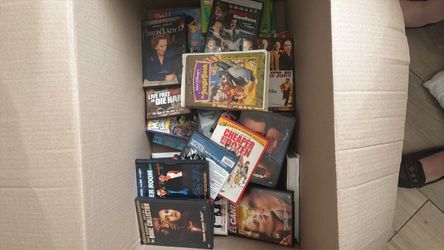 Box of various movies and VHS tapes