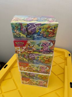 Pokémon Prismatic Evolutions sealed tin displays