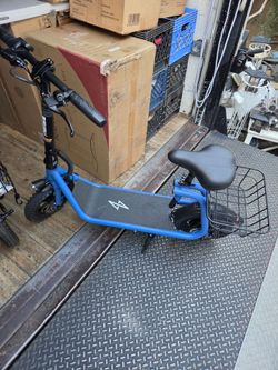 New Blue Phantom seated electric scooter 500W motor, 15.5 MPH top speed, 20-mile range. It includes 12-inch tires, a rear basket, a foldable frame