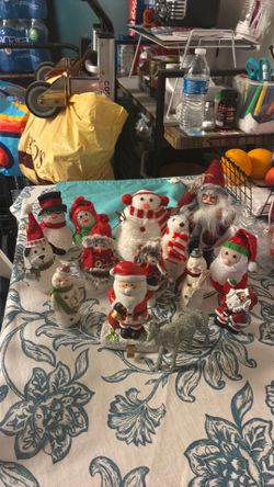 14 Christmas ornaments. Polar bears, Santa Claus in various forms, and a small silver deer.