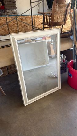 2 white bathroom mirrors
