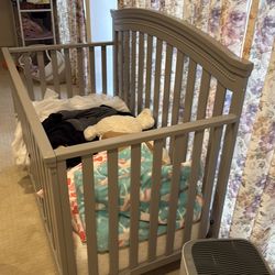 Grey wooden crib in excellent shape. Mattress included.