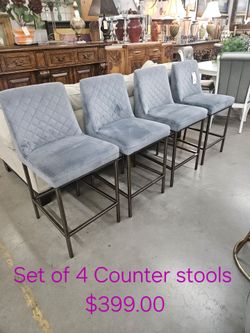 Set of 4 Gray Upholstered Counter Stools We are located at 2811 East Bell road. Another Time Around Furniture.