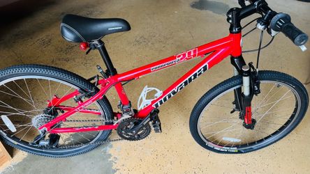 Red Novara mountain bike with 24-inch wheels.