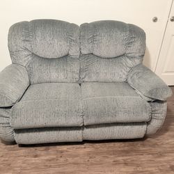 Double sofa in gray, both seats recline, brand new.