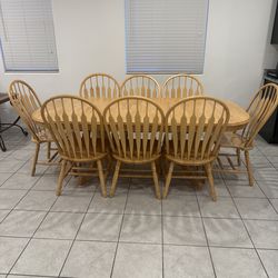 Dining room table with eight chairs, light wood