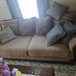 Very nice couch and love seat, tan with wood trim both come with extra pillows.