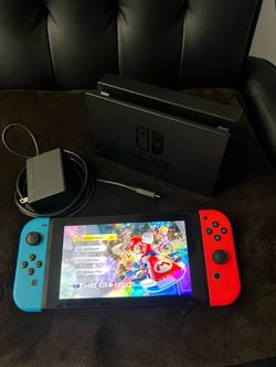 I'm selling a Switch console with its accessories; it includes the digital version of Mario Kart, and the console is in like-new condition.