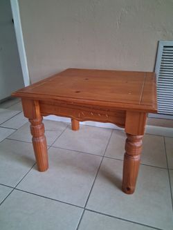 A solid pine real wood table 24 in x 24 in by 18 in high