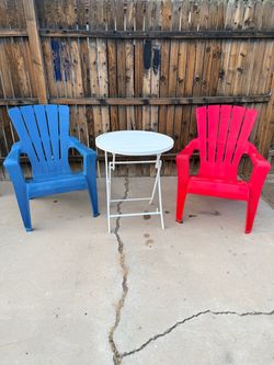 Set of 2 chairs with polypropylene frames and a 2.6 ft round folding table.
