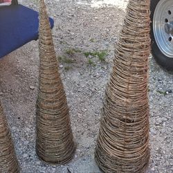 Three woven Christmas tree cones with lights