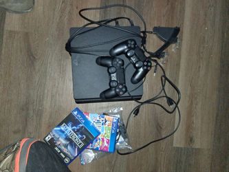 Playstation 4 with 2 wireless remotes and 2 games