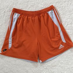 Adidas Orange Climalite Athletic shorts -Has a very small hole above Adidas logo on left opening  -Condition and measurements are as seen in photos  -