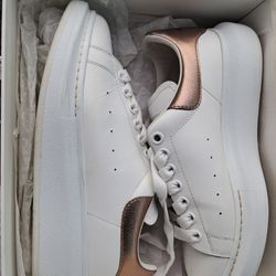 Alexander McQueen leather metallic-trimmed exaggerated sole sneakers. 