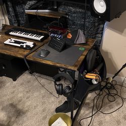 dark wood table with bad on the side headphone holder and mini table
