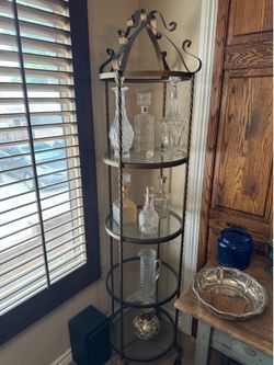 vintage wrought iron etagere with circular glass shelves