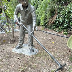 Bronze Boy Cleaning Leaves