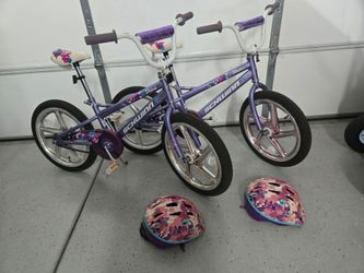 2 girls schwinn bikes 18 in with helmets