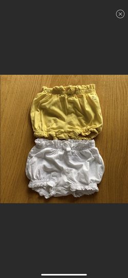Bundle of two baby girl bubble shorts. Excellent condition. Size 3-6m white shorts and 6-12m yellow shorts.